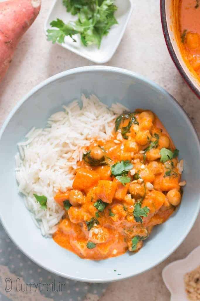 sweet potato curry with rice in blue ceramic bowl