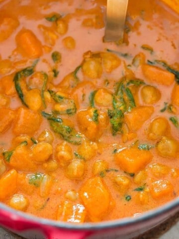 close up of thai curry with sweet potatoes and chickpeas cooked in pot