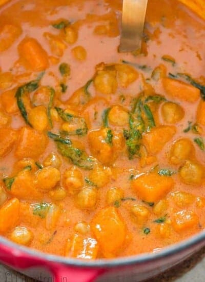 close up of thai curry with sweet potatoes and chickpeas cooked in pot