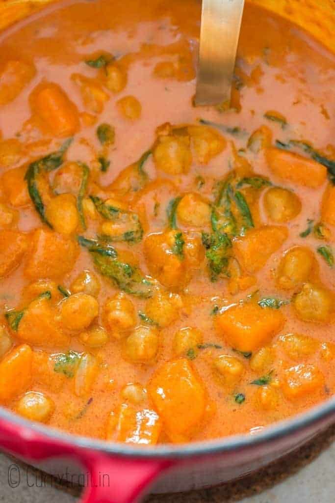 close up of thai curry with sweet potatoes and chickpeas cooked in pot
