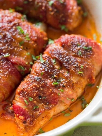 chicken breast wrapped with fatty bacon and baked until caramelized to perfection in baking dish