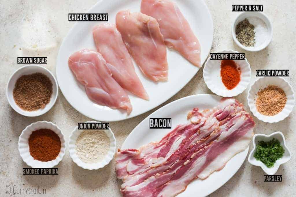 all ingredients for making bacon wrapped chicken recipe spread on white board