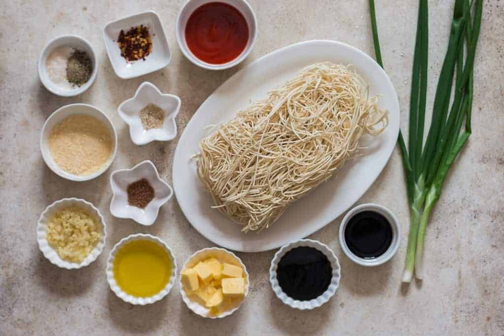 all ingredients for chili garlic noodles on white board