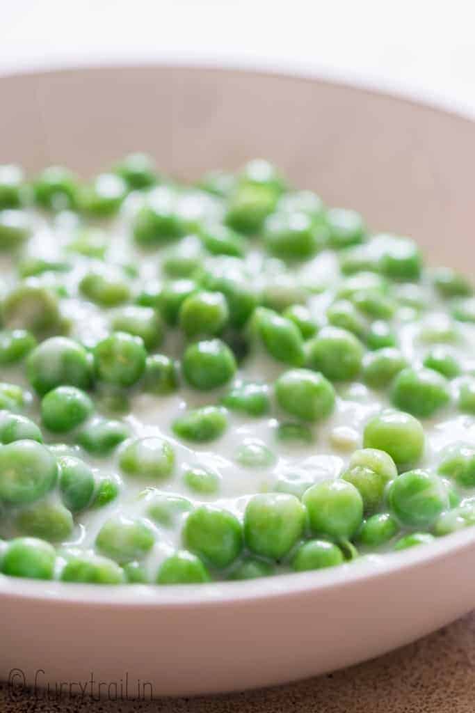 closeup of creamed peas in ceramic bowl