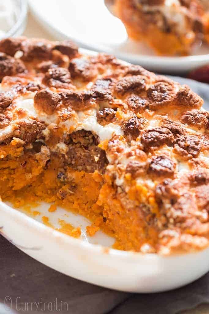 easy sweet potato casserole dish with mini marshmallow and pecan crumb topping in casserole dish with text overlay