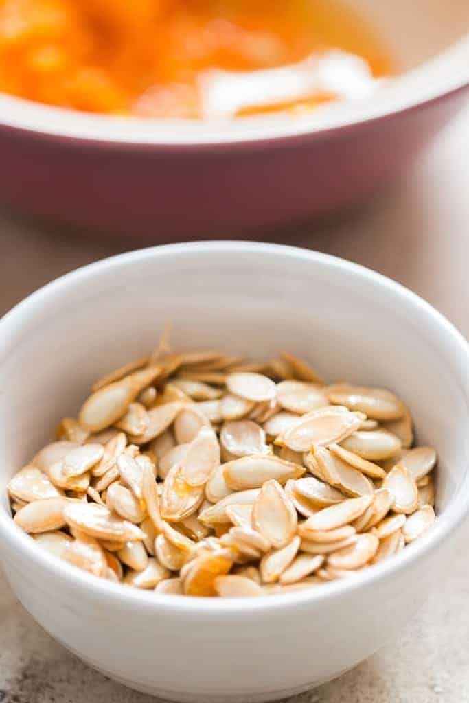 cleaned pumpkin seeds in white bowl