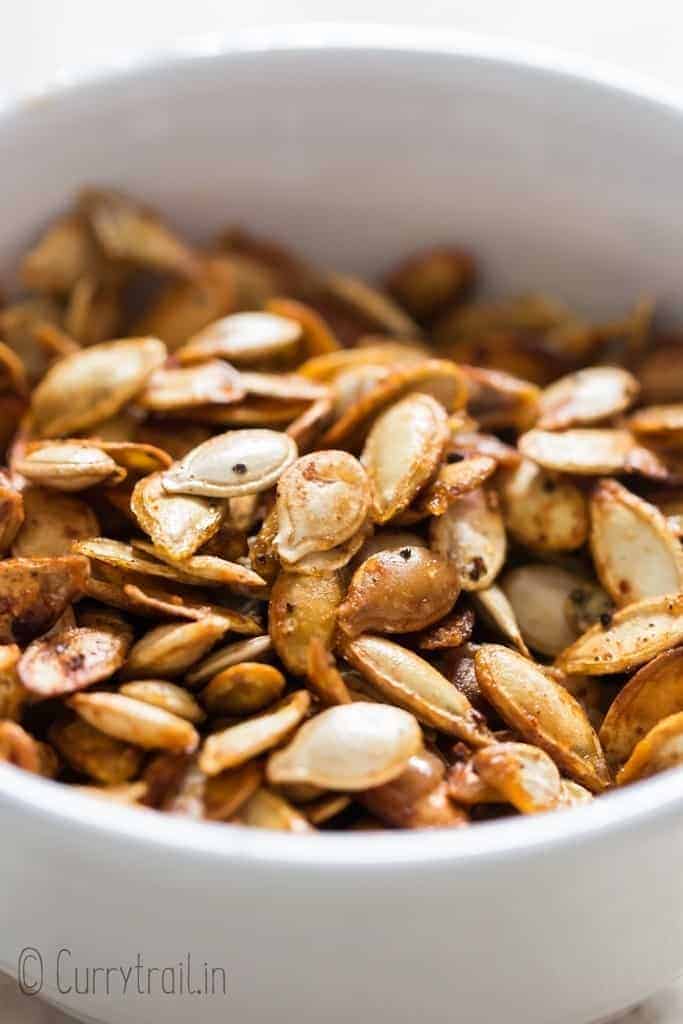 savory pumpkin seeds roasted in oven in ceramic bowl with text