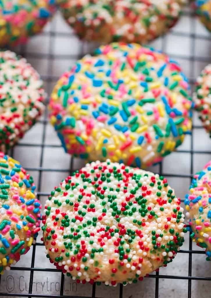 baked rainbow sprinkle sugar cookies cooling on wire rack