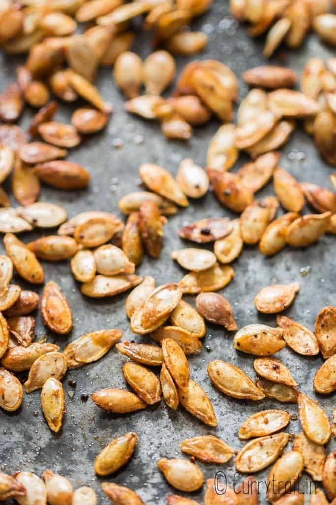 crunchy pumpkin seeds roasted in oven on baking tray