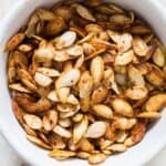 savory pumpkin seeds roasted in oven in ceramic bowl with text