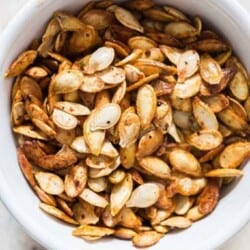 savory pumpkin seeds roasted in oven in ceramic bowl with text