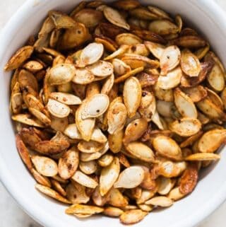 savory pumpkin seeds roasted in oven in ceramic bowl with text