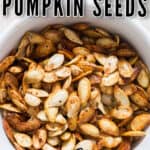 close up photo of savory roasted pumpkin seeds in ceramic bowl with text