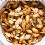 savory pumpkin seeds roasted in oven in ceramic bowl with text