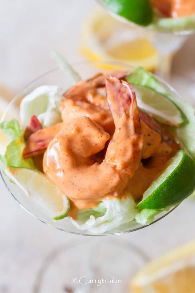 juicy jumbo size prawn in pink Marie sauce served in a cocktail glass.