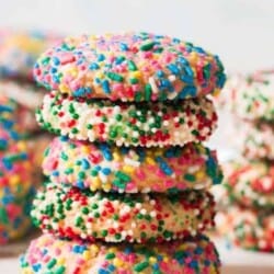 sprinkle cookies stacked up on white board