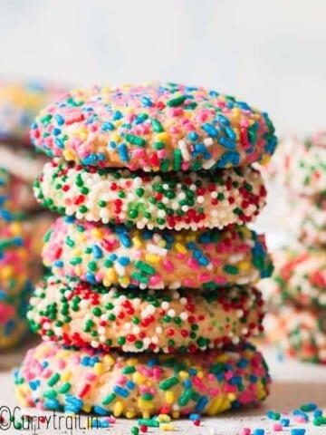 sprinkle cookies stacked up on white board