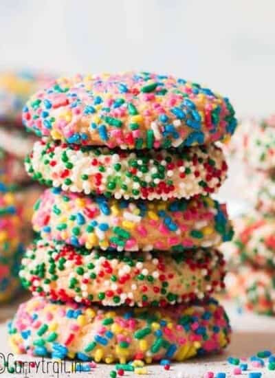 sprinkle cookies stacked up on white board