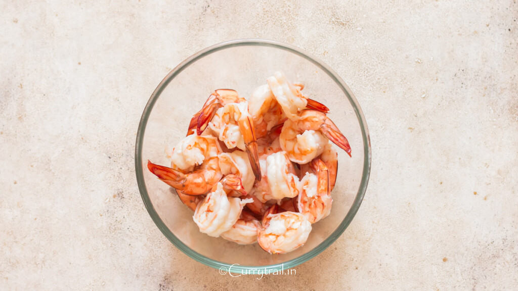 blanched prawns with tails in a bowl.