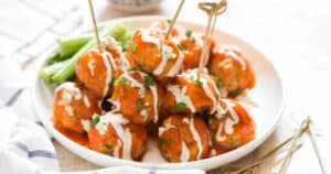 meatballs made of chicken with buffalo sauce and blue cheese dressing on top