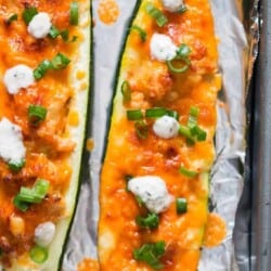 close up of chicken stuffed zucchini boats with buffalo chicken and ranch dressing