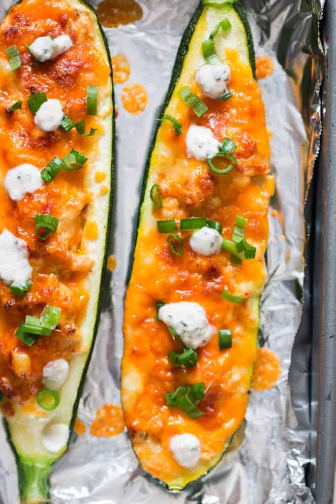 close up of chicken stuffed zucchini boats with buffalo chicken and ranch dressing