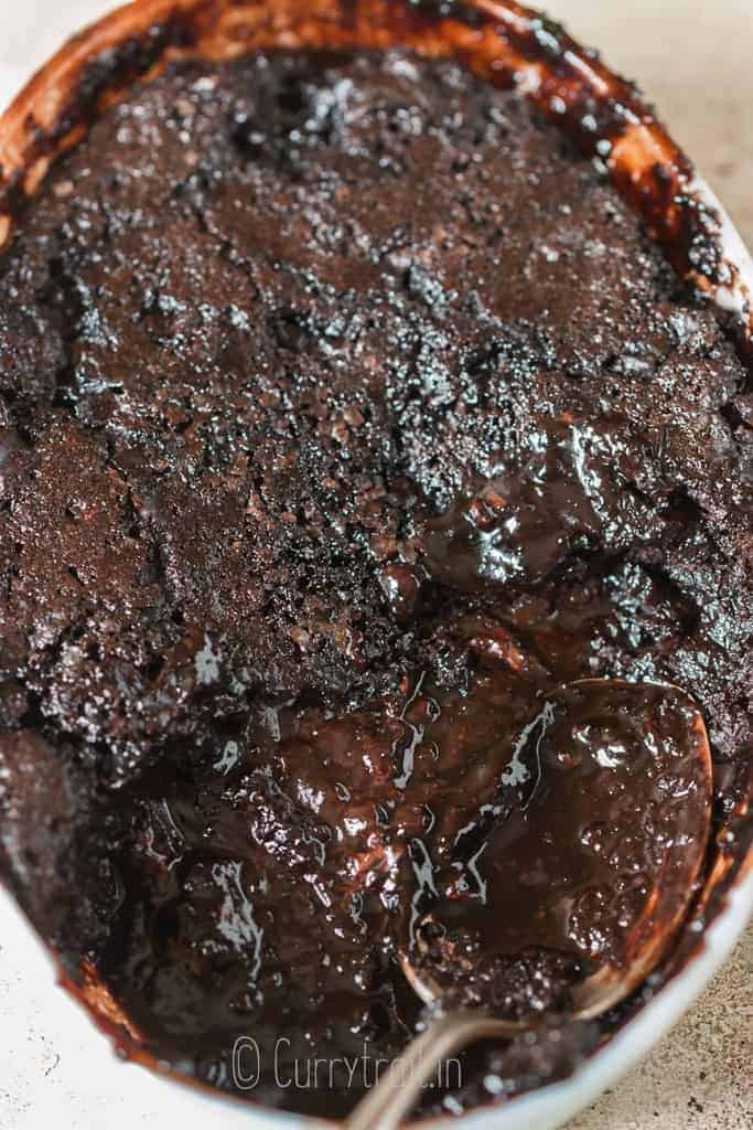 chocolate pudding cake with hot fudge sauce at the bottom in casserole baking dish