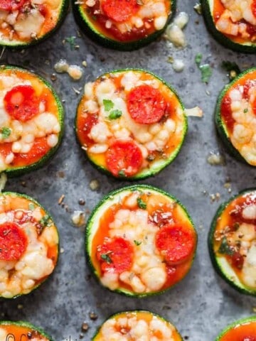 pizza bites with zucchini crust on baking tray with text overlay