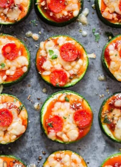 pizza bites with zucchini crust on baking tray with text overlay