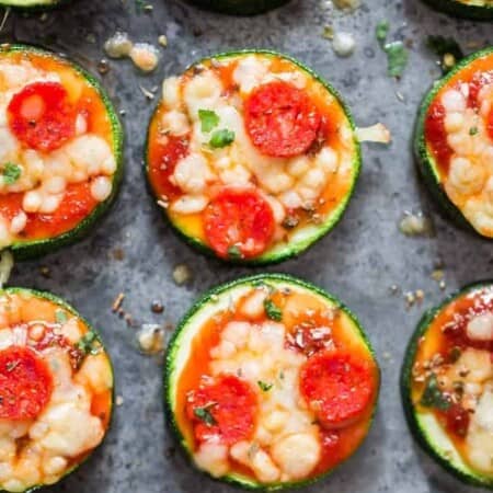 pizza bites with zucchini crust on baking tray with text overlay