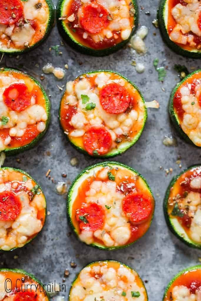 pizza bites with zucchini crust on baking tray with text overlay