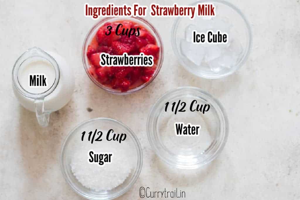 all ingredients for strawberry milk in cups on white board