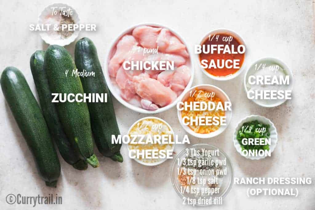 all ingredients for stuffed zucchini boats on white board