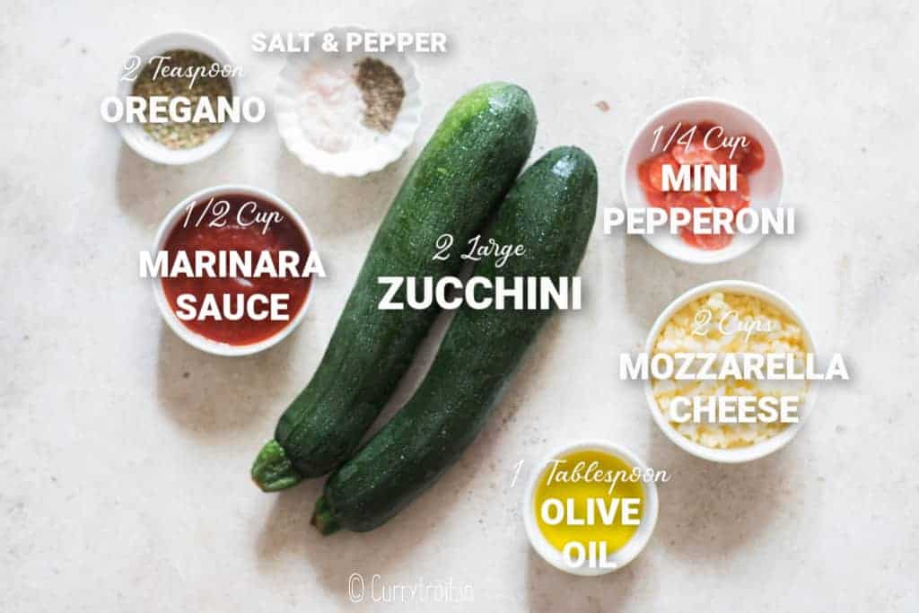 all ingredients for zucchini pizza bites on white board