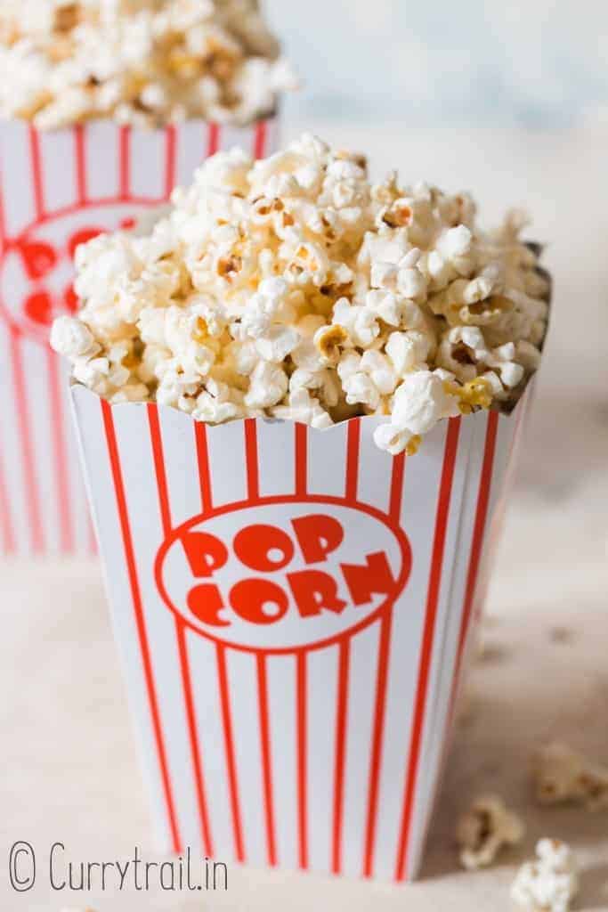 homemade movie popcorn in 2 popcorn tubs 