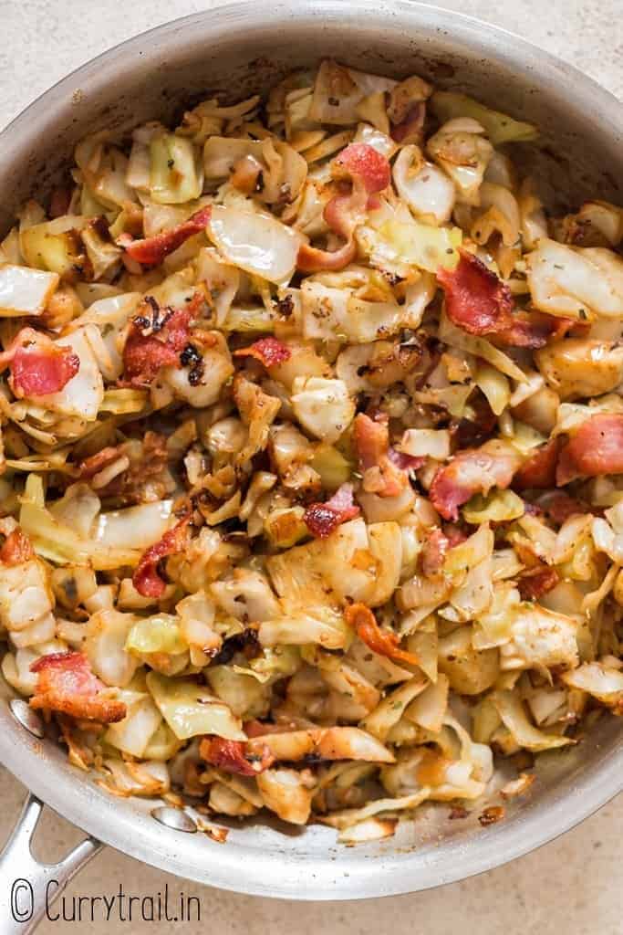 fried cabbage with bacon cooked in skillet