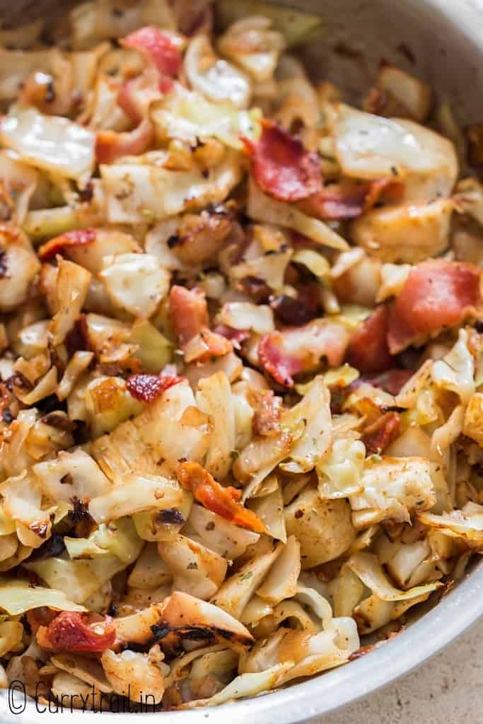 fried cabbage with bacon cooked in skillet