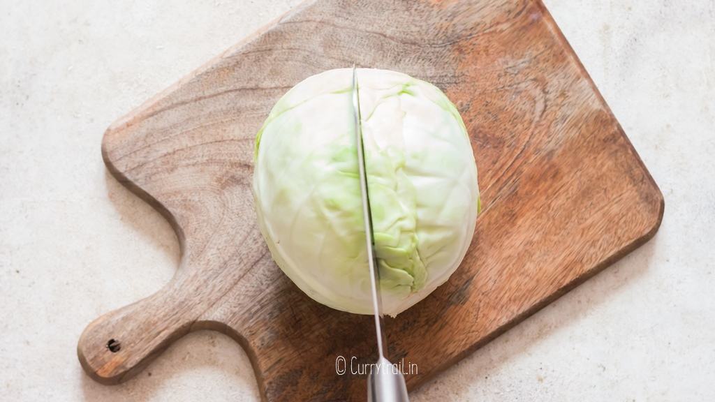 Slicing cabbage head into half