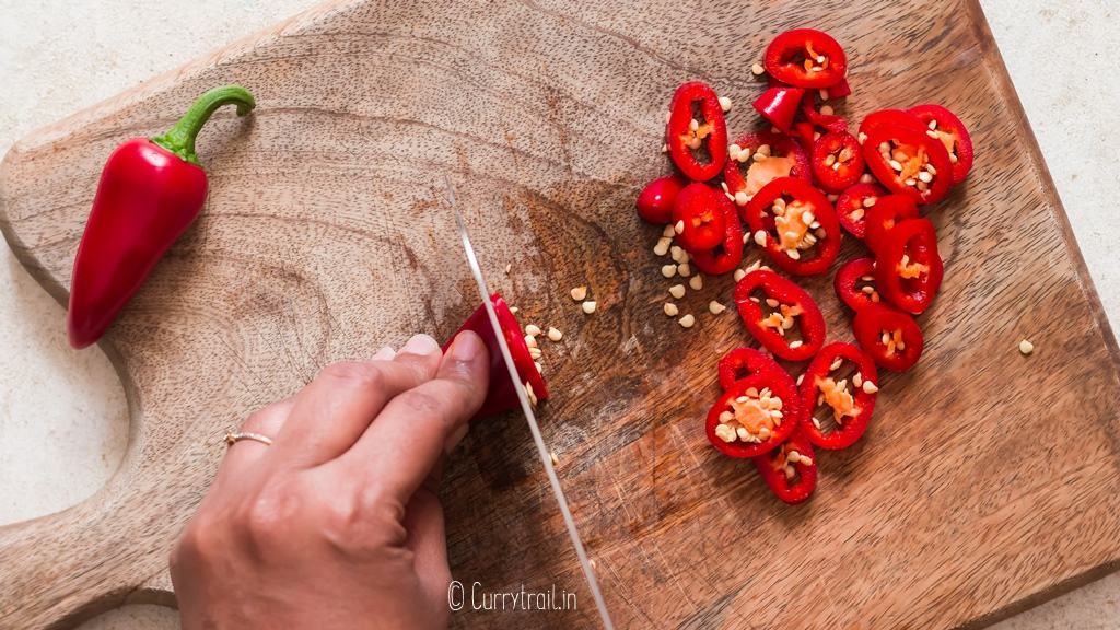 chopping fresno chilies to make hot honey recipe