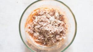 shredded chicken with buffalo cream sauce in bowl
