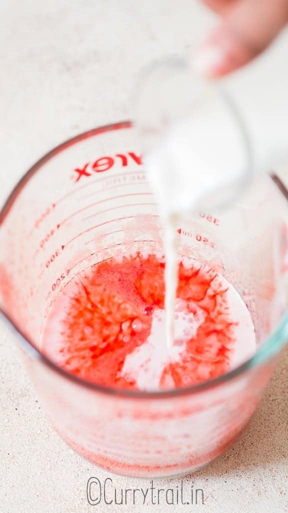 pouring milk into strawberry sauce