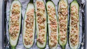 mozzarella cheese sprinkled on zucchini boats