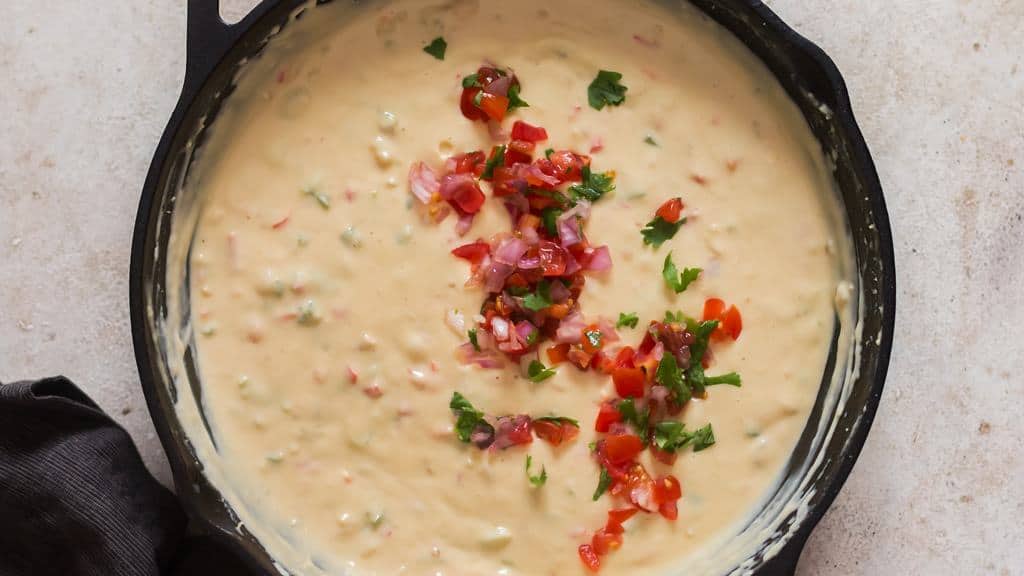 white queso dip and garnish with fresh pica de gallo in a skillet.