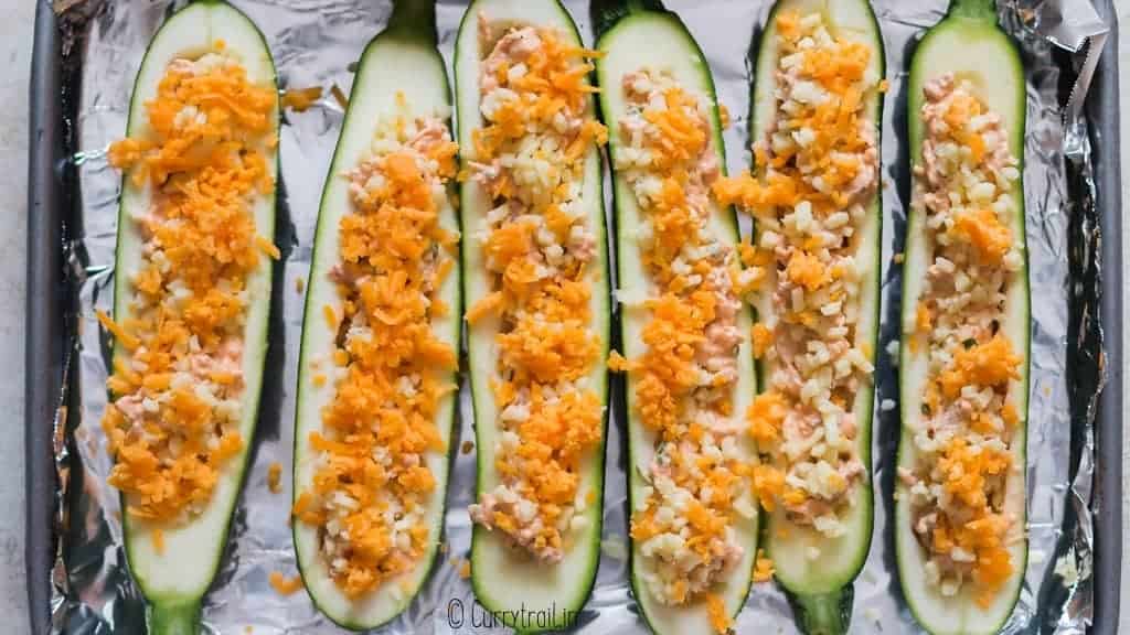 cheddar cheese sprinkled on zucchini boats