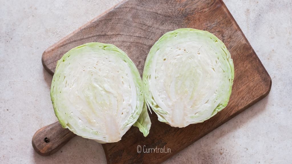 Slicing cabbage head into half