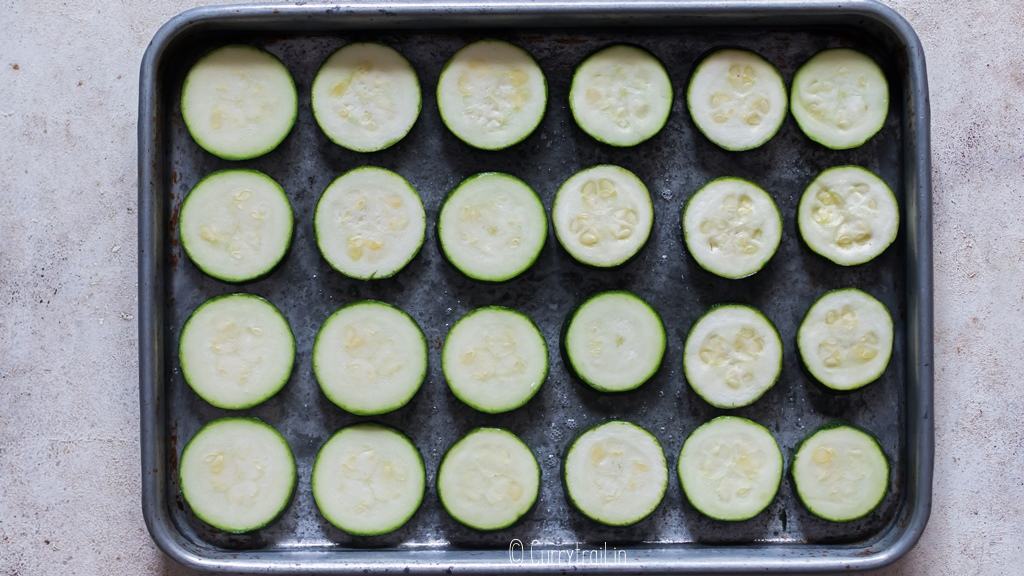 zucchini slices arranged on baking tray