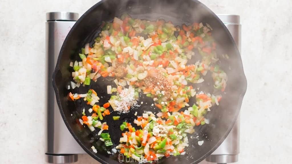 onion, garlic and cumin powder added to veggies