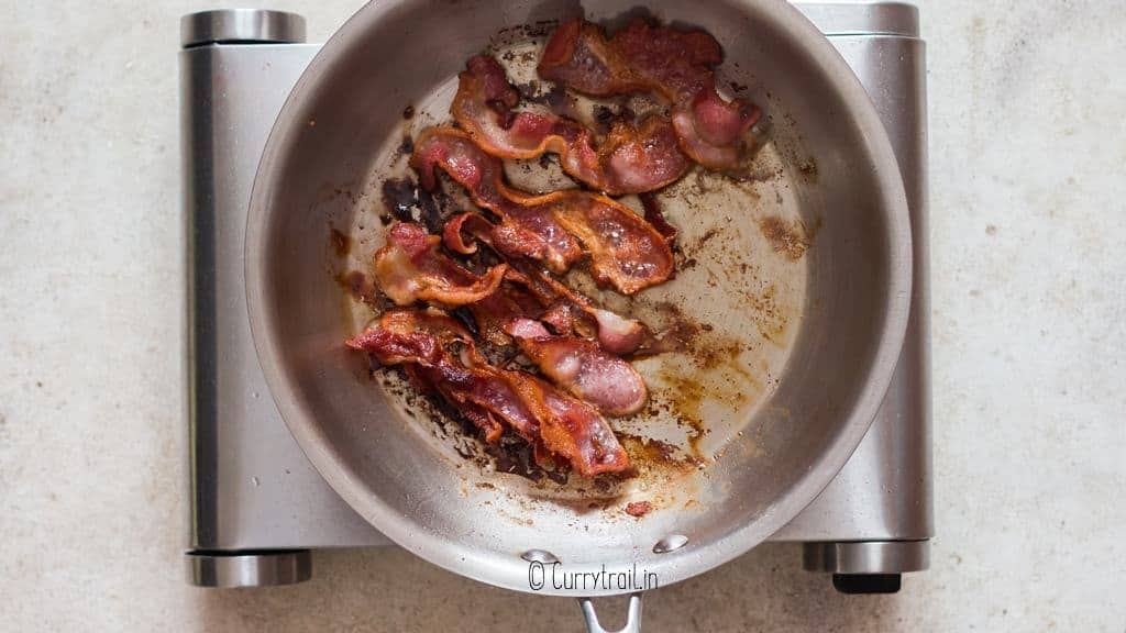 frying bacon until crispy in skillet