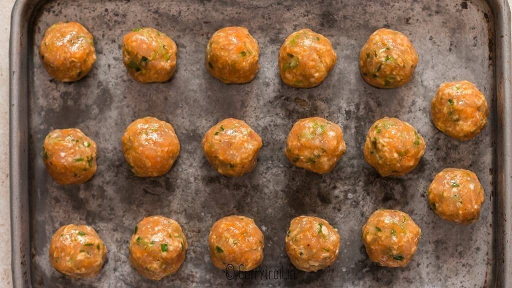 meatballs arranged on baking tray