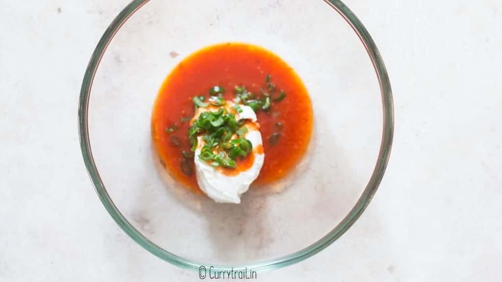 mixing cream cheese buffalo sauce, green onions